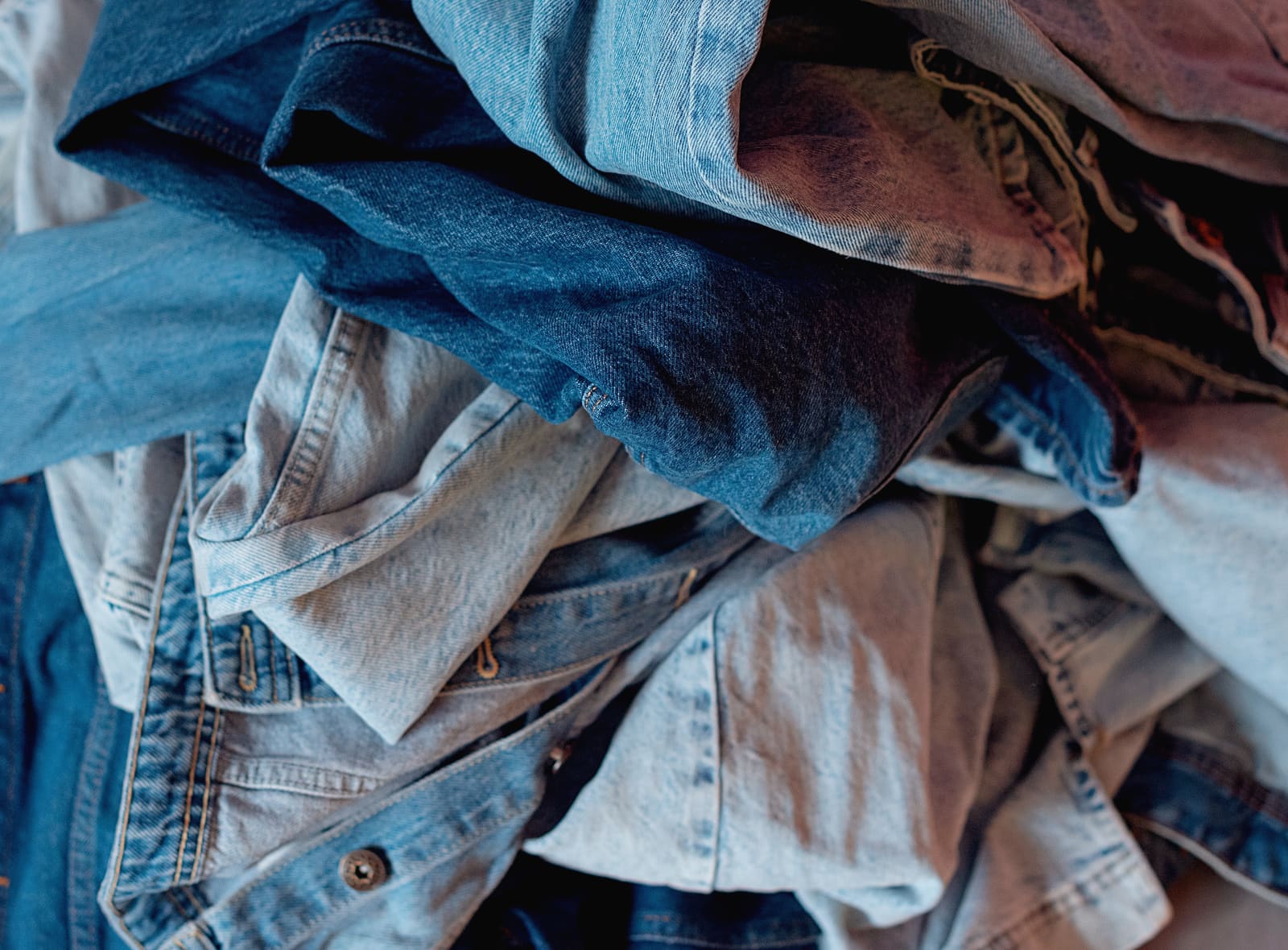 Closeup texture of a worn clothing pile.