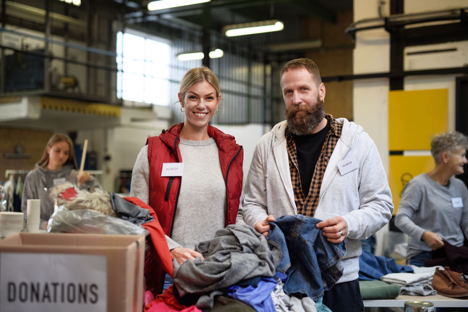 Volunteers sorting donated clothing at a community drive.